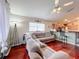 Living area with sectional sofa and hardwood floors, open to kitchen at 2508 Balmoral Dr, Kissimmee, FL 34744