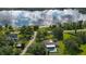 Aerial view of a home with pool, lakefront access, and lush landscaping at 2530 E New York Ave, Deland, FL 32724