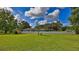 Large backyard with lush green grass and white vinyl fence at 2530 E New York Ave, Deland, FL 32724