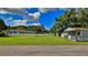 Spacious backyard with green grass, outbuilding and home at 2530 E New York Ave, Deland, FL 32724