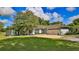 Light blue house exterior with a white garage door and spacious lawn at 2530 E New York Ave, Deland, FL 32724