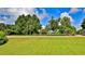 Neatly landscaped yard with a view of trees and road at 2530 E New York Ave, Deland, FL 32724