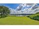 Serene lake view from a lush green lawn at 2530 E New York Ave, Deland, FL 32724
