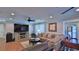 Living room with hardwood floors, large TV, and comfortable seating at 2530 E New York Ave, Deland, FL 32724