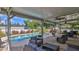 Inviting pool area with covered patio and seating at 2530 E New York Ave, Deland, FL 32724
