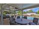 Relaxing covered patio with pool, outdoor seating, and dining area at 2530 E New York Ave, Deland, FL 32724
