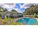 Inviting pool and patio with covered seating and lush landscaping at 2530 E New York Ave, Deland, FL 32724