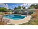 Stunning kidney-shaped pool surrounded by a well-manicured yard at 2530 E New York Ave, Deland, FL 32724