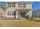 Two-story house with red shutters, double doors, and a landscaped yard at 3033 Meleto Blvd, New Smyrna Beach, FL 32168