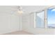 Bedroom with large window, ceiling fan, and water views at 3047 S Atlantic Ave # 1906, Daytona Beach, FL 32118
