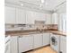 Efficient kitchen featuring white cabinets and built-in appliances at 3047 S Atlantic Ave # 1906, Daytona Beach, FL 32118