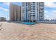 Community pool with patio and surrounding building views at 3047 S Atlantic Ave # 1906, Daytona Beach, FL 32118