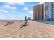 Community pool deck with ocean views, patio furniture, and umbrellas at 3047 S Atlantic Ave # 1906, Daytona Beach, FL 32118