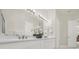 Double vanity bathroom with modern light fixtures and neutral tones at 310 La Creek Ct, Debary, FL 32713