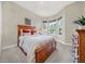 Bright bedroom with wooden bed frame and bay window at 310 La Creek Ct, Debary, FL 32713