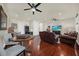 Bright bonus room features hardwood floors, a large TV, and ample seating at 310 La Creek Ct, Debary, FL 32713