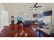 Spacious bonus room with hardwood floors, wet bar, and comfortable seating at 310 La Creek Ct, Debary, FL 32713
