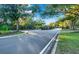 Residential street with lush landscaping and guard house entrance at 310 La Creek Ct, Debary, FL 32713