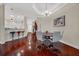 Spacious dining area with hardwood floors, modern table and kitchen view at 310 La Creek Ct, Debary, FL 32713