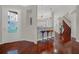 Bright entryway with hardwood floors and staircase to upper level at 310 La Creek Ct, Debary, FL 32713