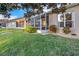 Rear view of house featuring a screened porch and green lawn at 310 La Creek Ct, Debary, FL 32713