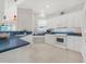 Modern kitchen with white cabinets, blue countertops, and stainless steel appliances at 310 La Creek Ct, Debary, FL 32713