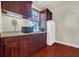 Well-equipped kitchenette with dark wood cabinets and modern appliances at 310 La Creek Ct, Debary, FL 32713