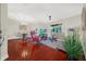 Bright open-plan living and dining area with hardwood floors, neutral walls and sliders to the lanai at 310 La Creek Ct, Debary, FL 32713