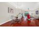 Bright open-plan living and dining area with hardwood floors, neutral walls and modern stylish decor at 310 La Creek Ct, Debary, FL 32713