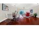 Bright open-plan living and dining area with hardwood floors, neutral walls and modern stylish decor at 310 La Creek Ct, Debary, FL 32713