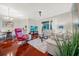Bright open-plan living and dining area with hardwood floors, neutral walls and sliders to the lanai at 310 La Creek Ct, Debary, FL 32713