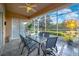 Spacious screened porch with lake view and dining furniture at 310 La Creek Ct, Debary, FL 32713