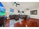 Spacious sitting area with leather furniture, hardwood floors, and large TV at 310 La Creek Ct, Debary, FL 32713