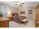 Cozy bedroom with wood furniture and a ceiling fan at 319 Bellingrath Ter, Deland, FL 32724