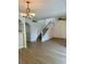Living area with staircase, wood-look flooring and chandelier at 334 Scottsdale Sq # 334, Winter Park, FL 32792