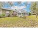 Landscaped backyard featuring a spacious pool and screened enclosure at 34 Black Creek Way, Ormond Beach, FL 32174