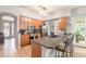 Modern kitchen with light wood cabinets, stainless steel appliances, and an island at 34 Black Creek Way, Ormond Beach, FL 32174