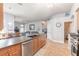 Open concept kitchen with island, stainless steel appliances, and tile flooring at 34 Black Creek Way, Ormond Beach, FL 32174