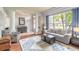Living room with hardwood floors, comfy seating, and large windows at 34 Black Creek Way, Ormond Beach, FL 32174
