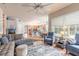 Open living room featuring hardwood floors, a kitchen view, and ample natural light at 34 Black Creek Way, Ormond Beach, FL 32174