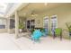 Relaxing covered patio with fire pit and comfortable seating at 34 Black Creek Way, Ormond Beach, FL 32174