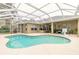 Inviting pool area with screened enclosure, providing ample space for relaxation and entertainment at 34 Black Creek Way, Ormond Beach, FL 32174