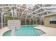 Enjoy this refreshing pool with a screened enclosure and basketball hoop nearby at 34 Black Creek Way, Ormond Beach, FL 32174