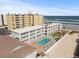 Aerial view of building, pool, and beach access at 3509 S Atlantic Ave # 208, New Smyrna Beach, FL 32169