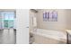 Bathroom featuring a soaking tub, shower and walkout to balcony at 3737 S Atlantic Ave # 502, Daytona Beach, FL 32118