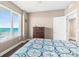 Bedroom with a dark wood floor and dresser, large window, and bright lighting at 3737 S Atlantic Ave # 502, Daytona Beach, FL 32118