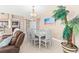 Bright dining area features a glass-top table, seating for six, and coastal decor at 3737 S Atlantic Ave # 502, Daytona Beach, FL 32118