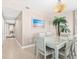 Hallway with tile flooring and beach-themed artwork, illuminated by stylish lighting fixtures at 3737 S Atlantic Ave # 502, Daytona Beach, FL 32118