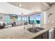 Kitchen featuring granite counters and a sink, with a view of an open living room and balcony overlooking the ocean at 3737 S Atlantic Ave # 502, Daytona Beach, FL 32118