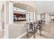 Kitchen view showcasing granite counters, rich wood cabinets, a breakfast bar, and open access to additional living spaces at 3737 S Atlantic Ave # 502, Daytona Beach, FL 32118